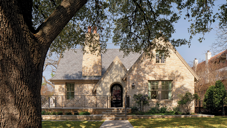 exterior of stone house with tree in front