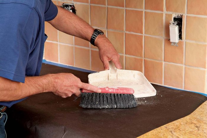 Sweep up debris before covering counters for further demolition.