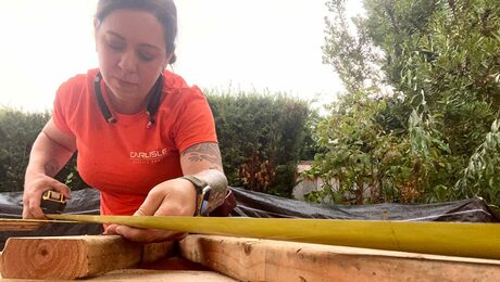 Dejah Leger measuring wood