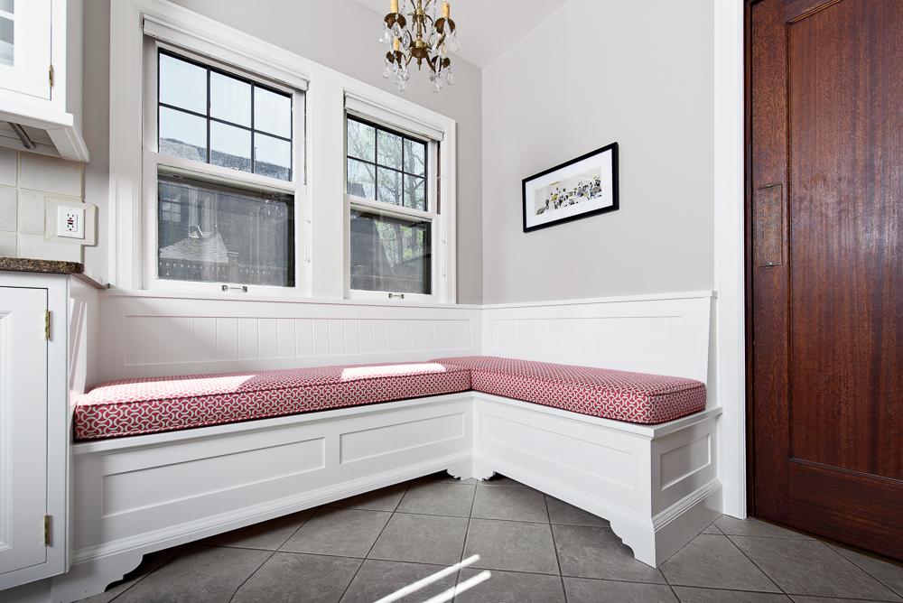 Once painted and fitted with cushions, the finished bench looks right at home, adding hidden storage, flexible seating, and increased flow to a busy kitchen.