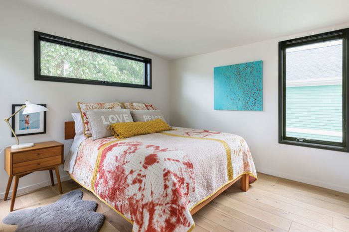 Bedroom with light floors and dark trim