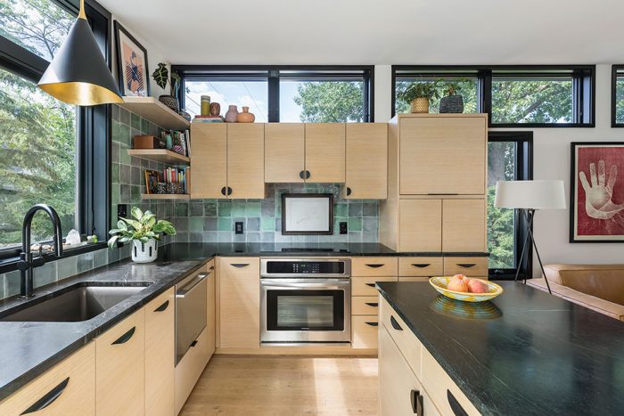 Kitchen with light wood cabinetry and soapstone counters