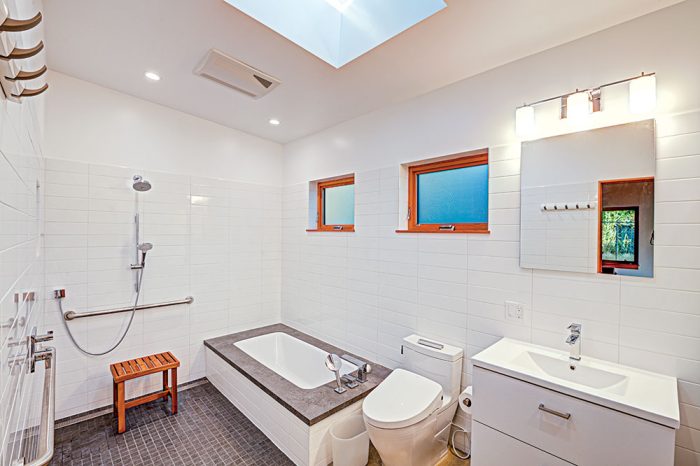 A white bathroom with a curbless shower