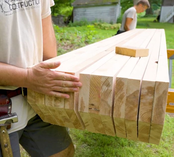 Photo of Jeremy Kassel ganging together eleven pergola rafters.