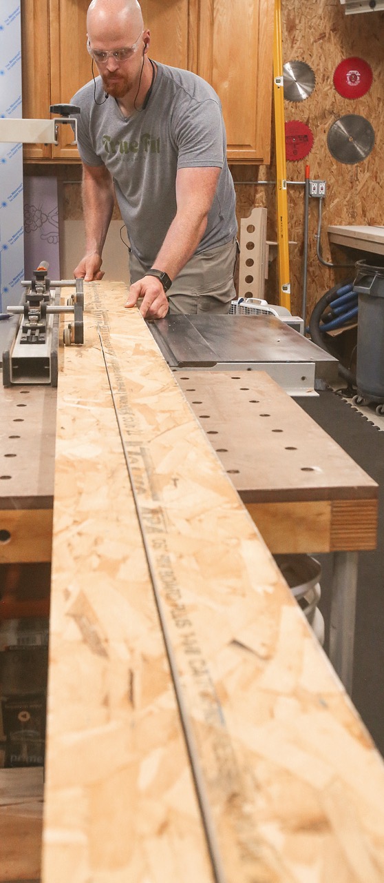 Photo of Casey Knips using a tablesaw in his shop.