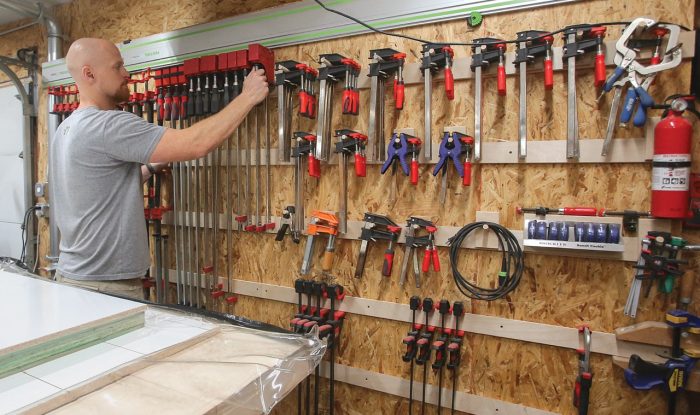 Photo of a clamp storage wall in Casey Knips' shop.