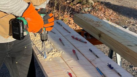 Photo of someone drilling into wood with wood boring bits